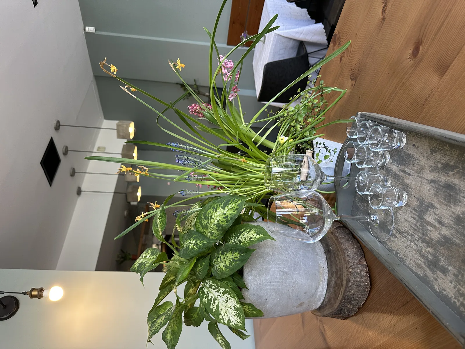 Table at COOKaki with wine glasses, fresh plants and Greek hospitality, near the Acropolis