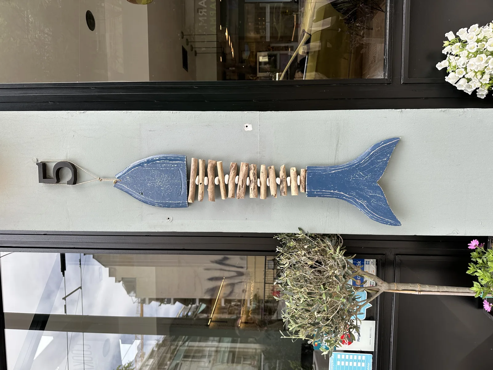 Blue fish detail above the entrance of COOKaki Bell Kitchen, Petméza 5 Athens